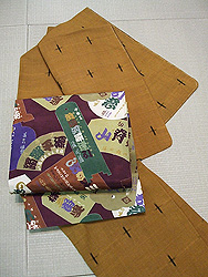 十字絣紬袷に演目札柄染名古屋帯