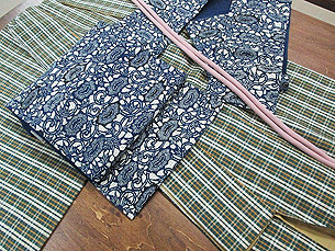 浦野理一作 深緑地格子紬に浦野理一作 手紡糸紬牡丹唐草型染め名古屋帯