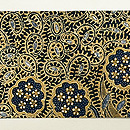 藍と茶の花や葉 インドネシア バティックの名古屋帯(木綿)　前柄